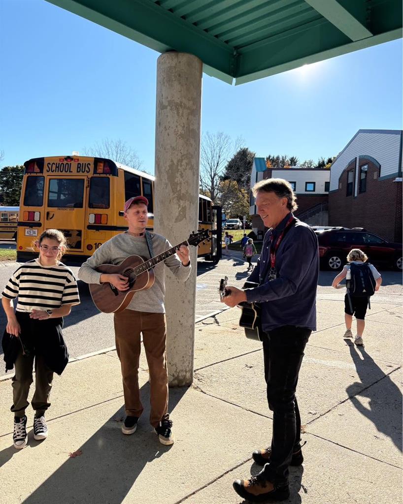 Mr. Gagnon and Dr. Selby play music for students as they leave school on Friday afternoon